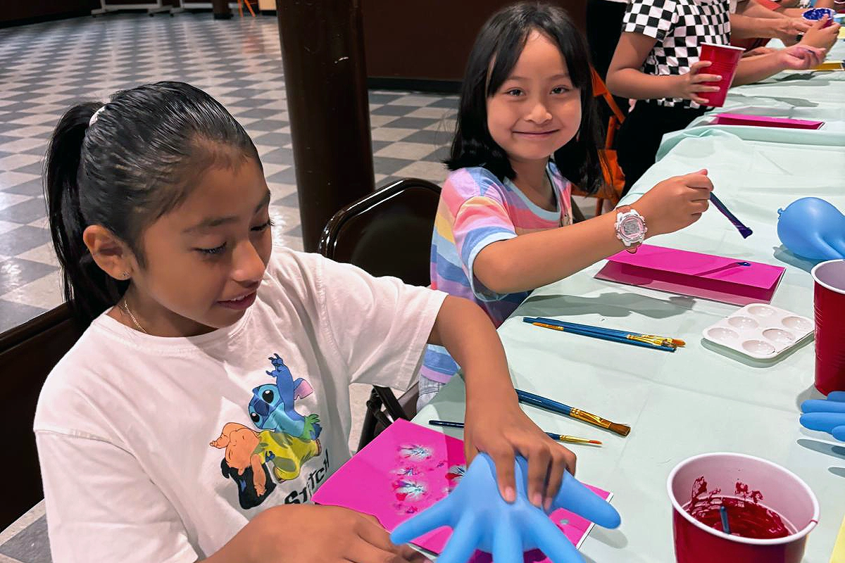 Students practicing various painting techniques in a calm and safe art class environment in Brooklyn.