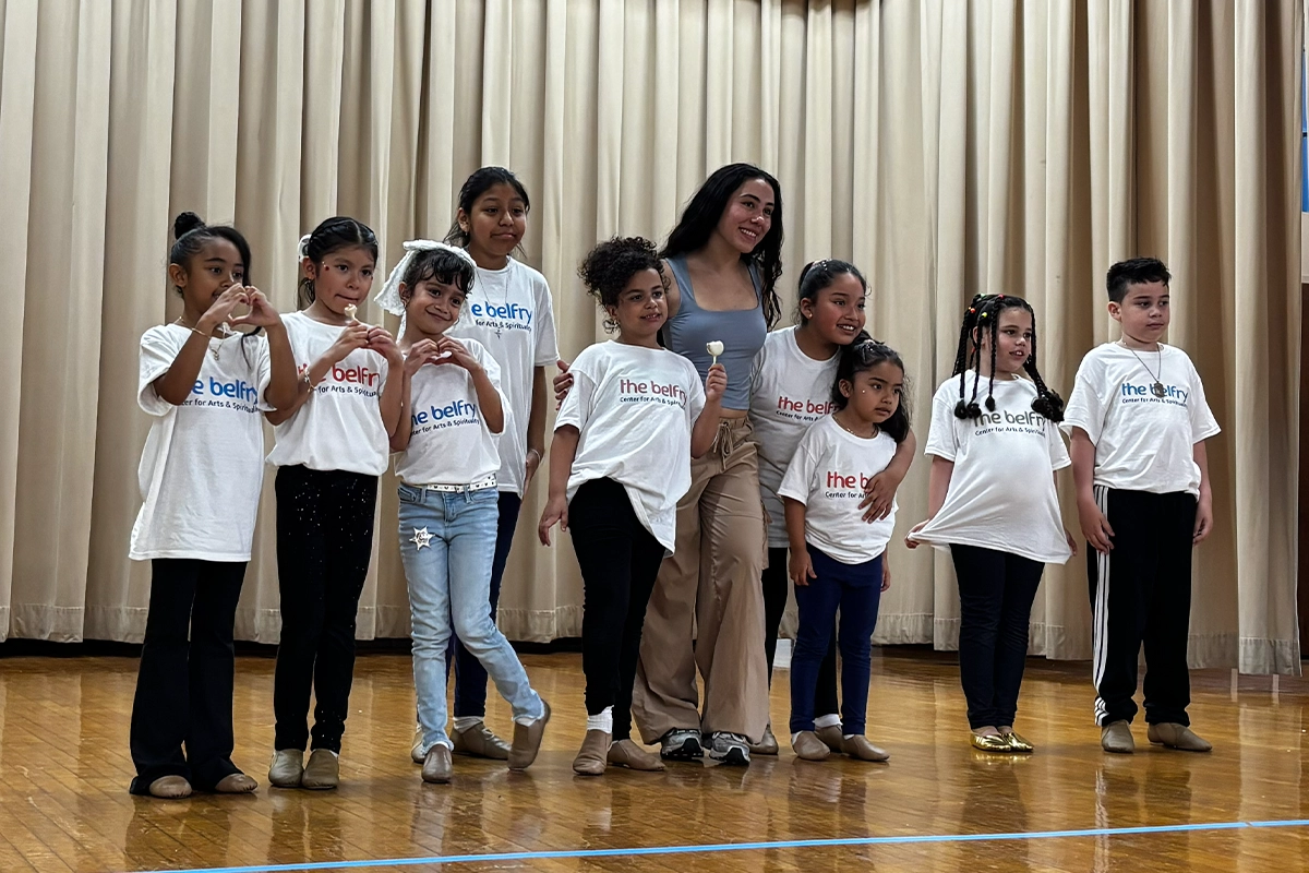 Group of students smiling with their dance teacher after a successful showcase performance at The Belfry Centre in Brooklyn.